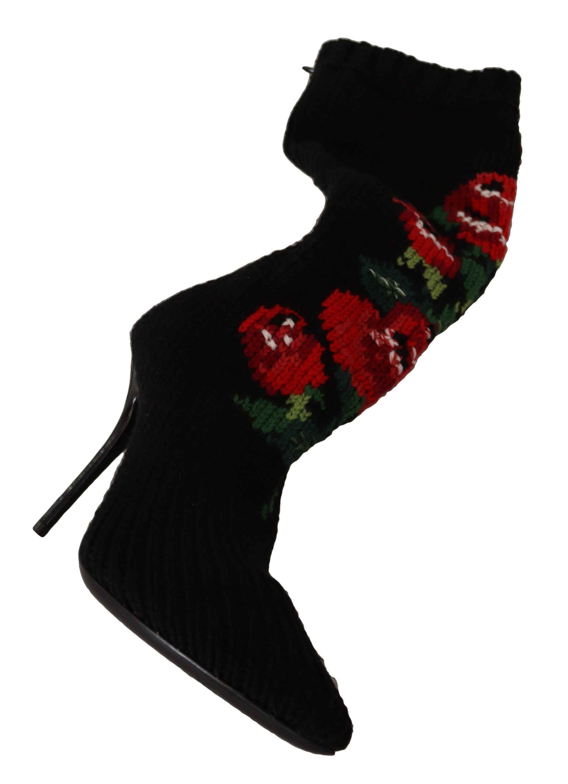 Chaussettes extensibles noires Dolce & Gabbana avec motifs de roses rouges, portées avec des bottines élégantes.
