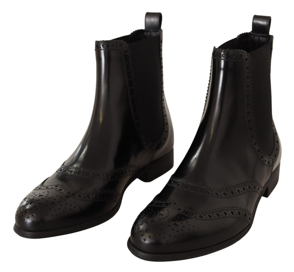 Chaussures Dolce & Gabbana bottines en cuir noir à la cheville, talons plats et style élégant.