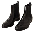 Chaussures Dolce & Gabbana bottines en cuir noir à la cheville, talons plats et style élégant.