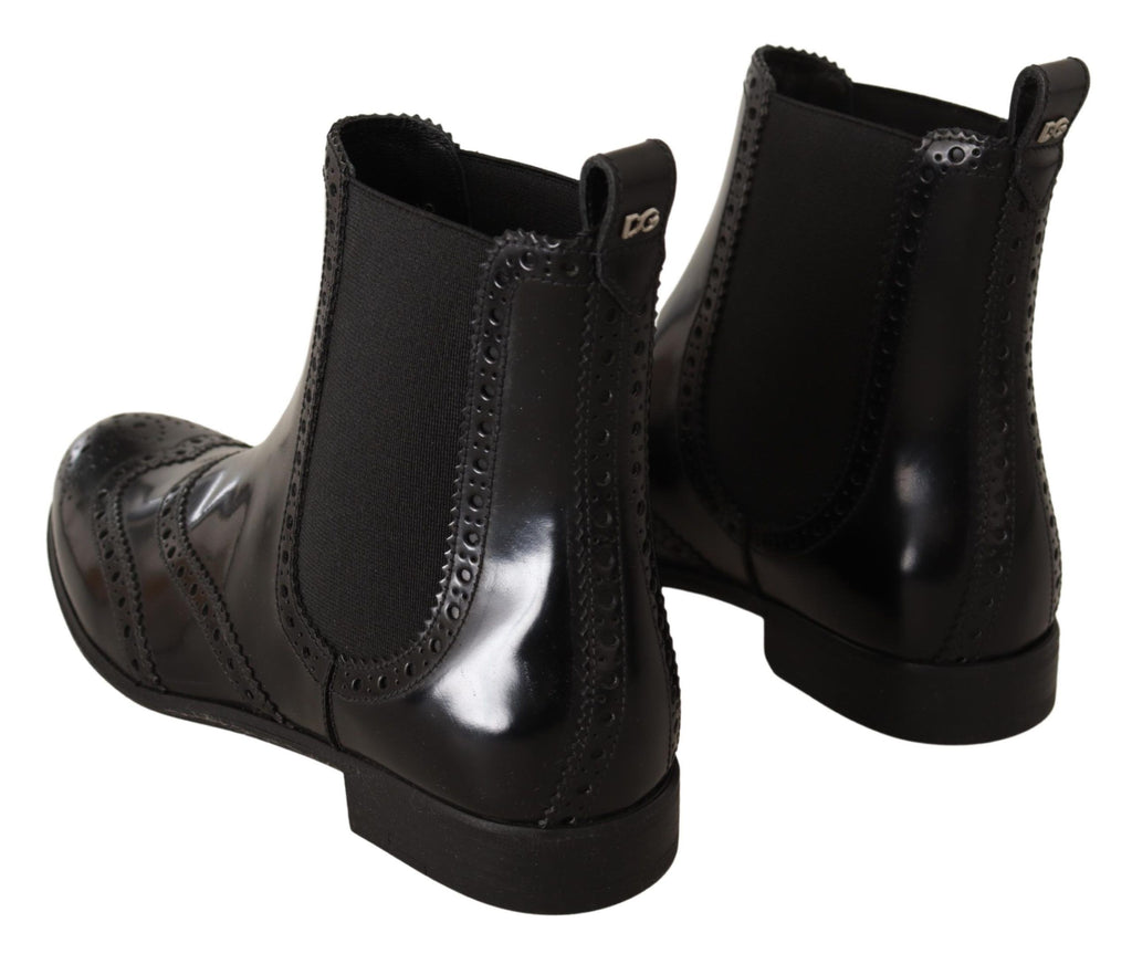 Bottes plates noires en cuir à la cheville de Dolce & Gabbana, chaussures élégantes et confortables pour un style sophistiqué.