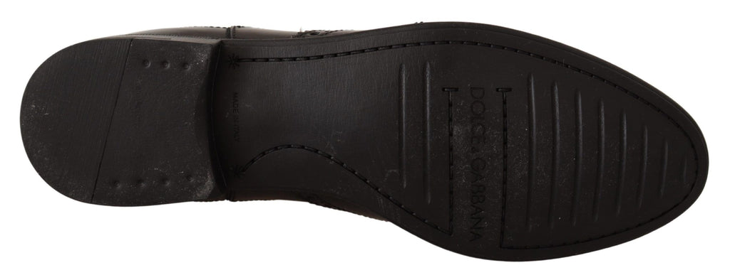 Bottes plates noires en cuir de la marque Dolce & Gabbana, bottines à la cheville avec semelle plate.