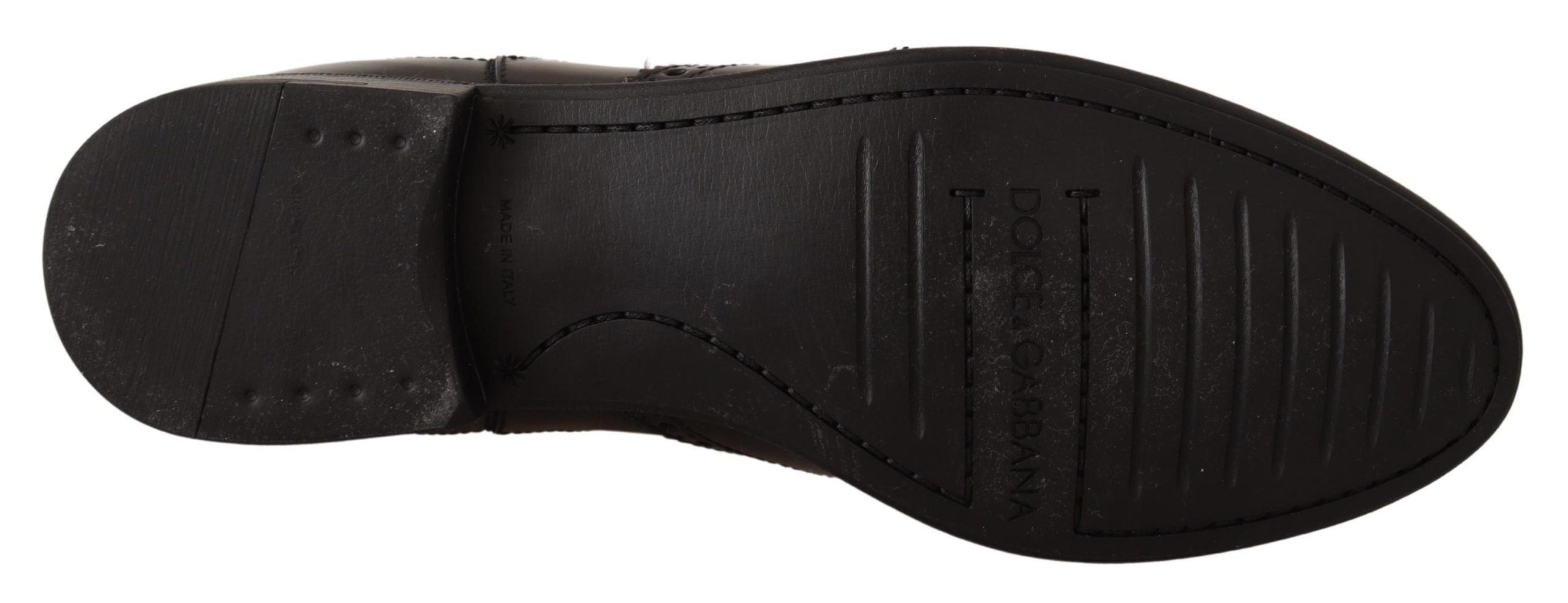 Bottes plates noires en cuir de la marque Dolce & Gabbana, bottines à la cheville avec semelle plate.