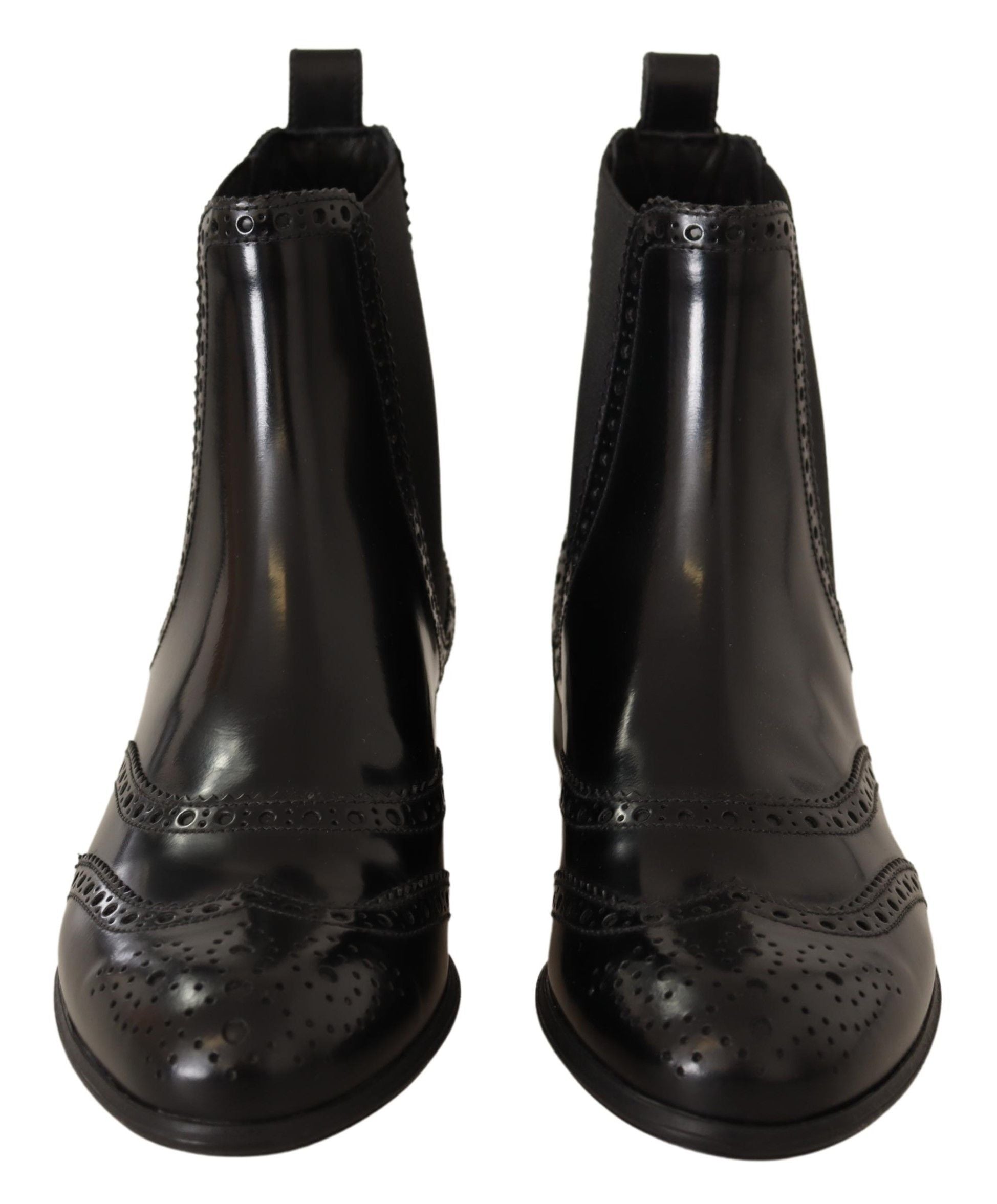 Bottes plates noires en cuir à la cheville de Dolce & Gabbana, style élégant et moderne, visibles sur l'image.