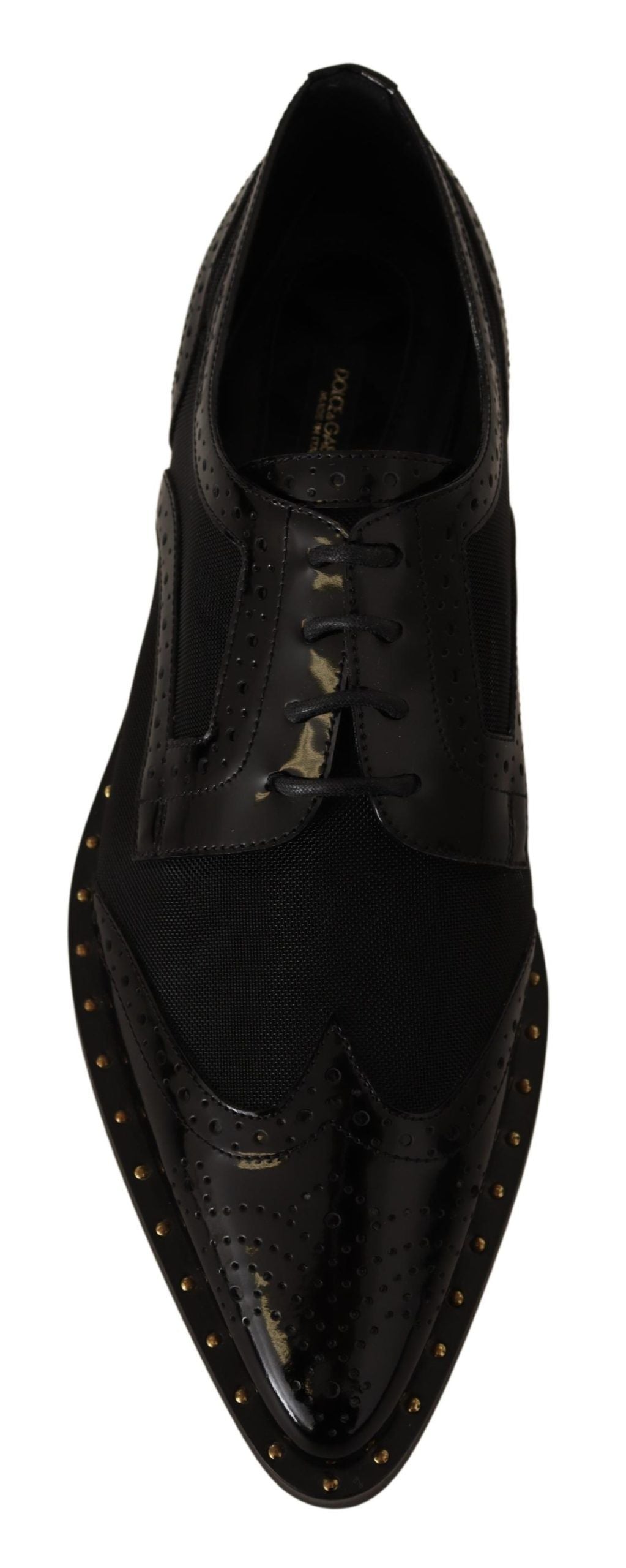 Chaussures wingtip en cuir noir Dolce & Gabbana, brogue transparent, style élégant et sophistiqué pour homme.