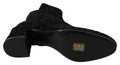 Bottes courtes noires Dolce & Gabbana à imprimé léopard avec fermeture éclair, style élégant et tendance.