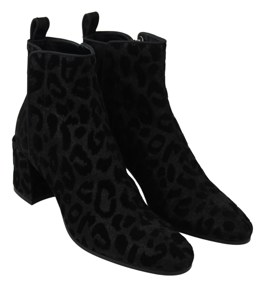 Bottes courtes à fermeture éclair Dolce & Gabbana en cuir noir avec motif léopard, style élégant et tendance.