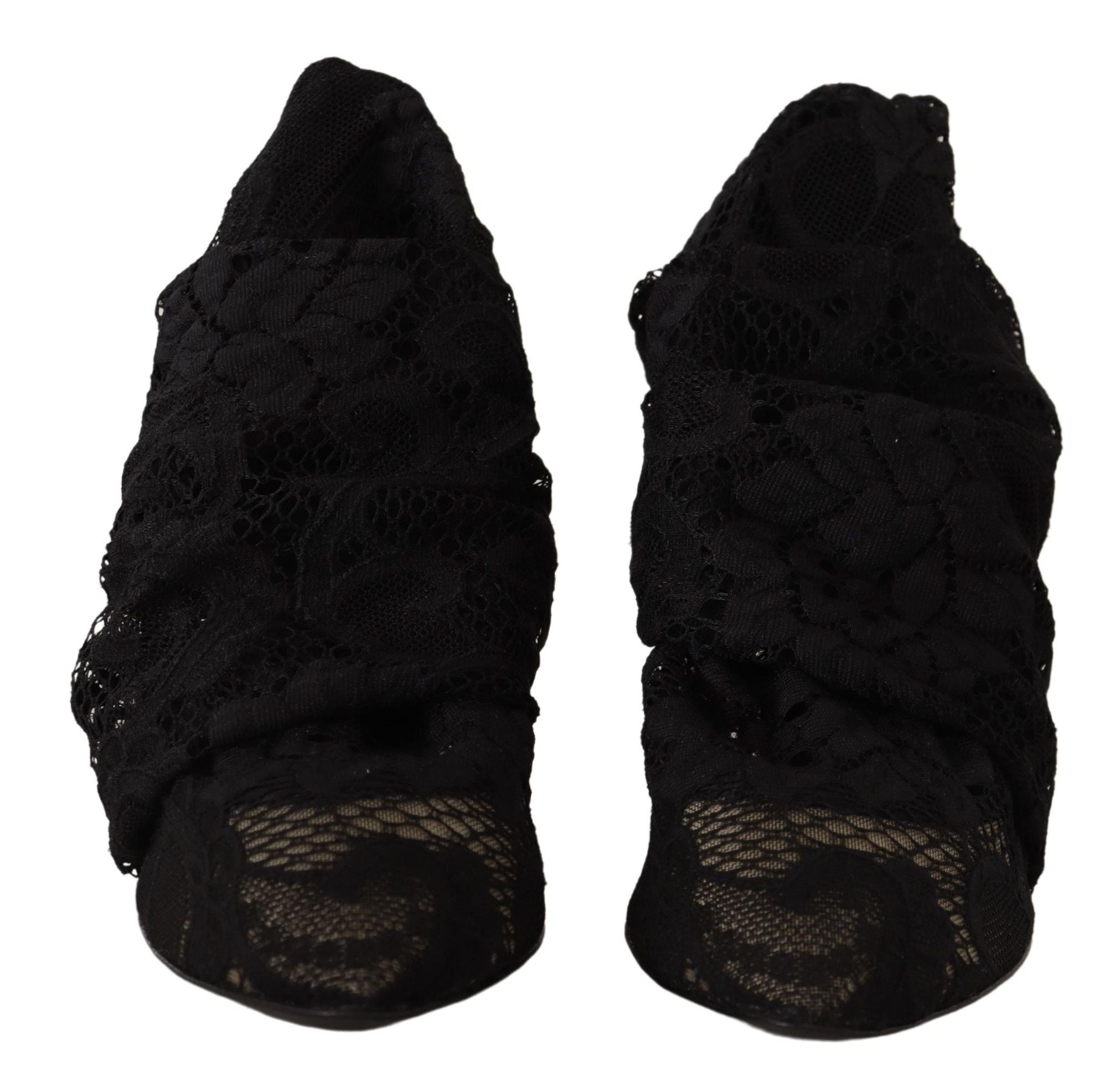 Chaussettes extensibles noires Dolce & Gabbana Taormina avec dentelle, portées avec des bottes en cuir noir.
