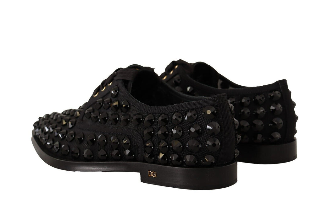 Chaussures plates formelles en cuir noir Dolce & Gabbana avec laçage et clous, parfaites pour une tenue élégante.