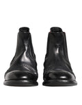 Chaussures bottines en cuir noir Dolce & Gabbana, style slip-on, pour femmes, vue de profil sur fond blanc.