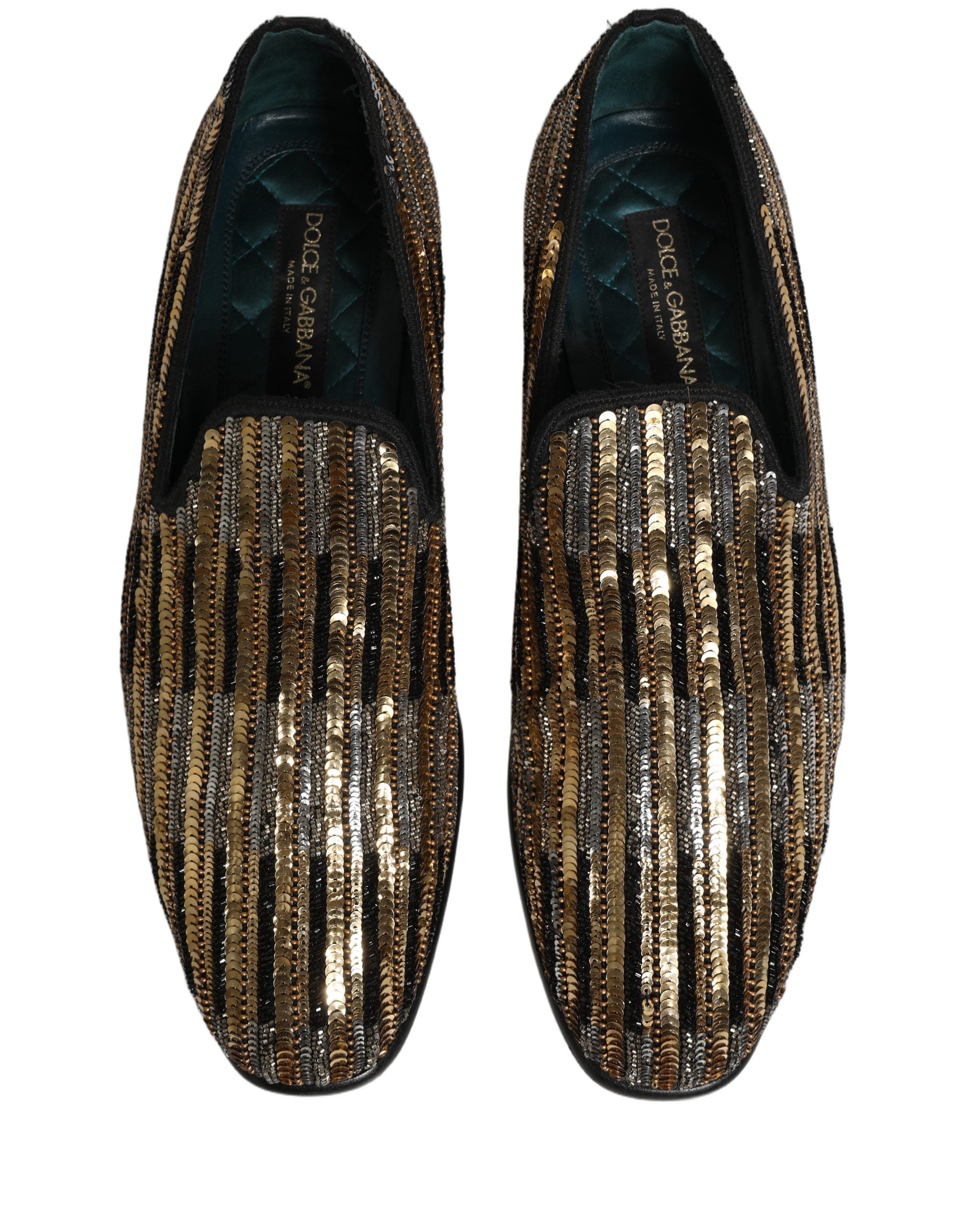 Chaussures loafers Dolce & Gabbana en sequins dorés à rayures, ornées de détails embellis, vue de face sur fond neutre.