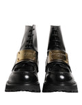 Bottes en cuir noir Dolce & Gabbana avec plaque DG, lacets et semelle robuste, mode élégante et sophistiquée.