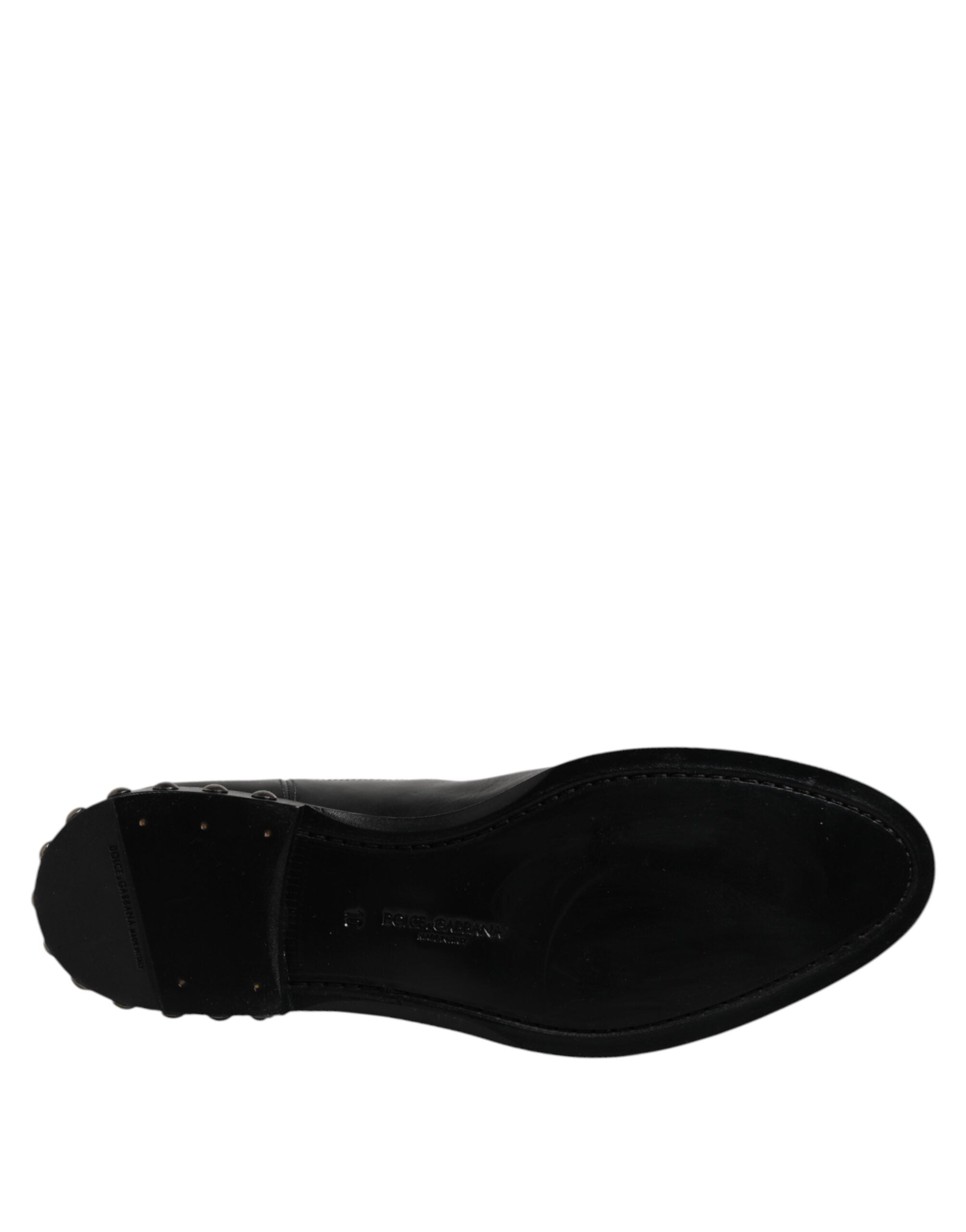 Bottes Chelsea en cuir noir Dolce & Gabbana avec logo, clous et semelle en caoutchouc, style élégant et tendance.