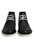 Bottes ankle en cuir noir et blanc de Dolce & Gabbana, chaussures élégantes avec détails sophistiqués.