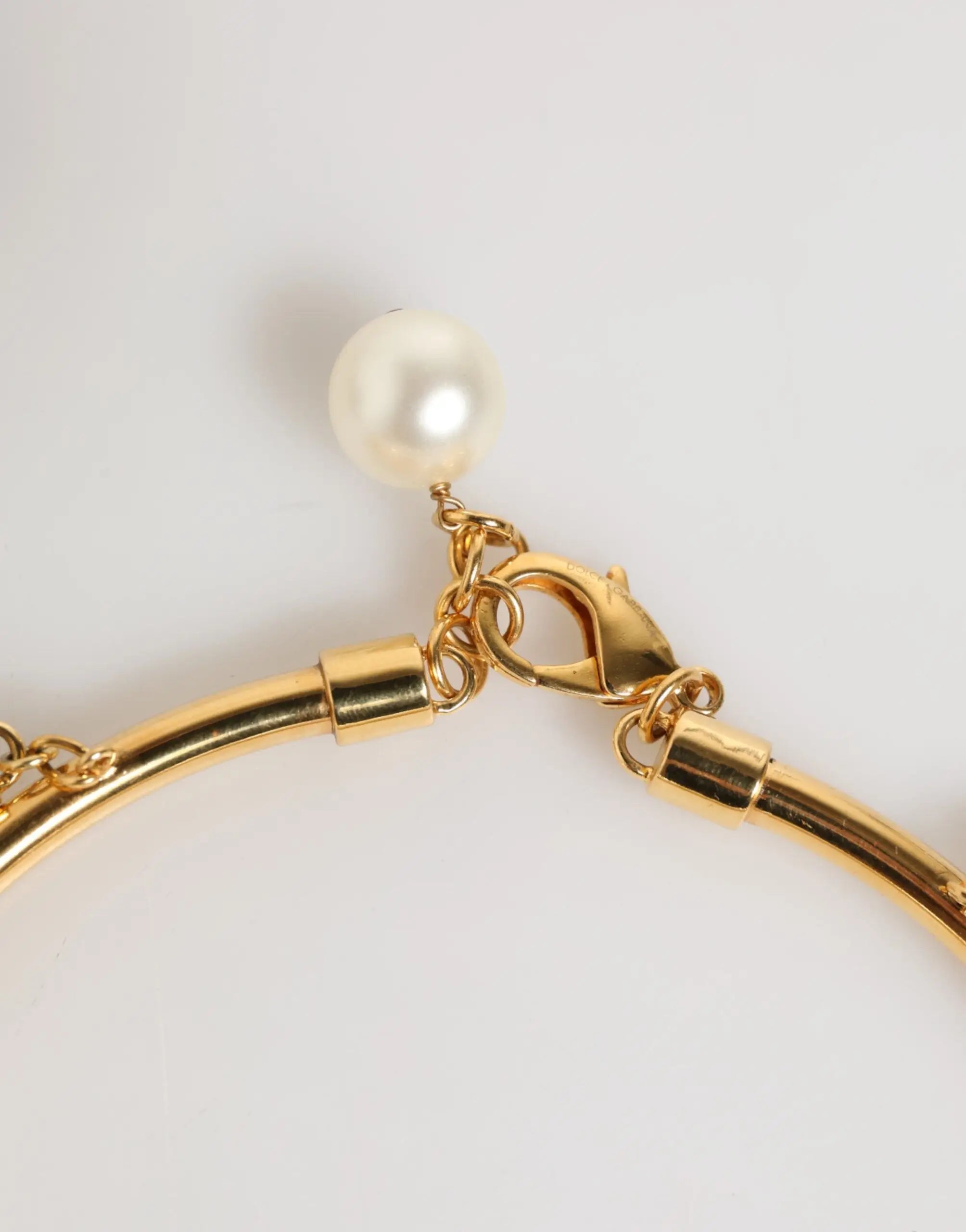 Bracelet doré dolce & gabbana avec chaîne cylindrique lisse et perle blanche nacrée luxueuse