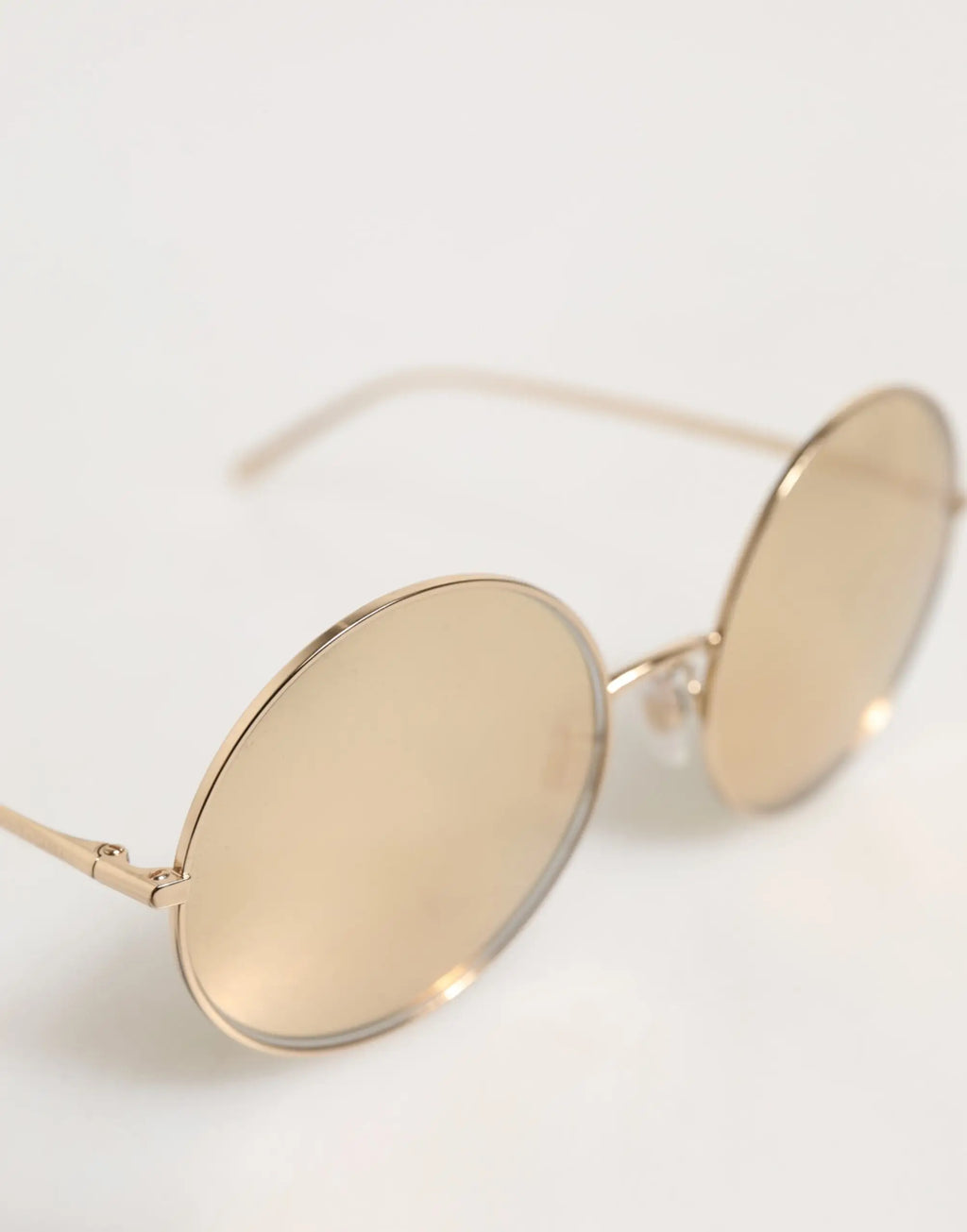 Lunettes de soleil rondes en métal doré dolce & gabbana avec verres miroir pour un style élégant