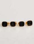 Quatre bagues ajustables dolce & gabbana en laiton doré avec lettres jazz en émail noir et argent sur le dessus