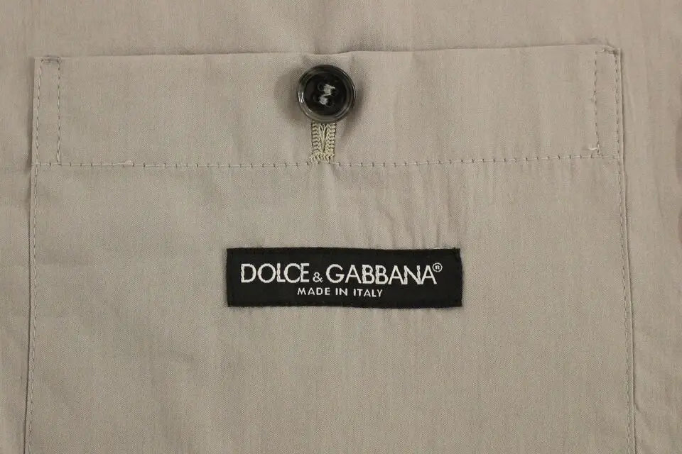 Beige dolce & gabbana shirt pocket with black button and brand label on a gray cotton slim fit dress vest