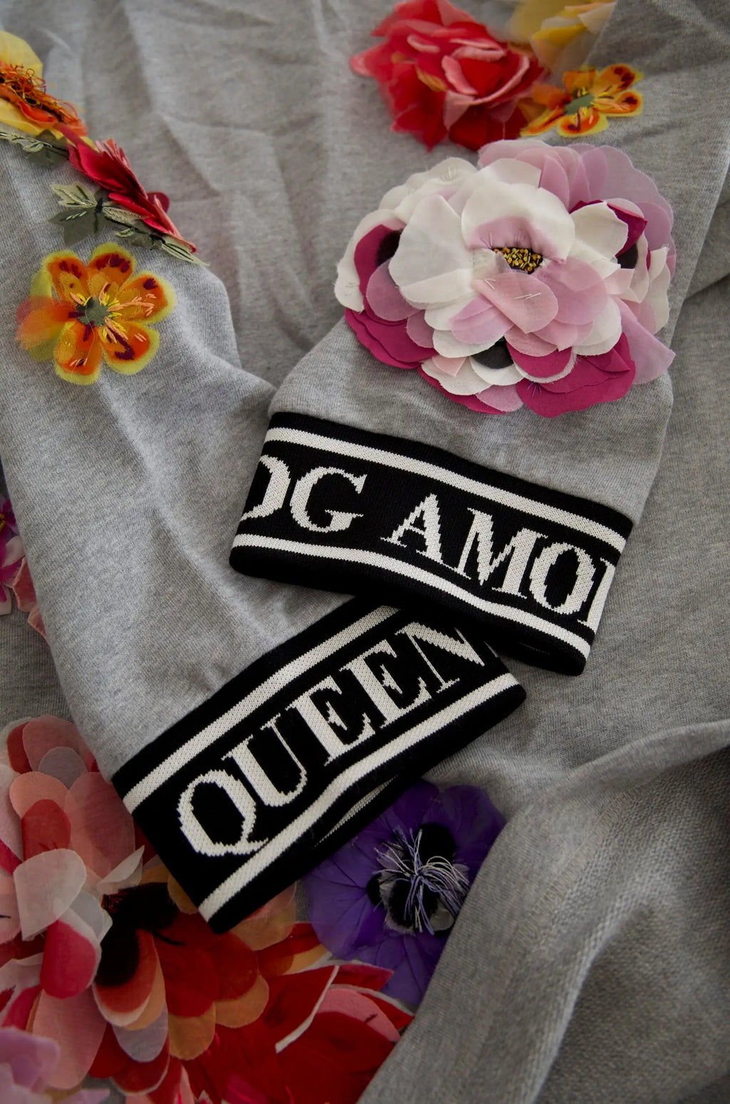 Bonnet gris en maille dolce gabbana avec bande rayée noire et blanche queen et fleur rose en tissu superposée