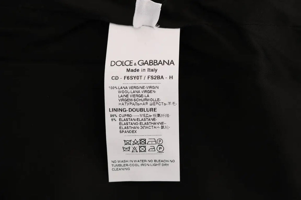 Étiquette d’entretien blanche dolce & gabbana avec texte noir décrivant la composition et l’entretien de robe fourreau laine grise à pois