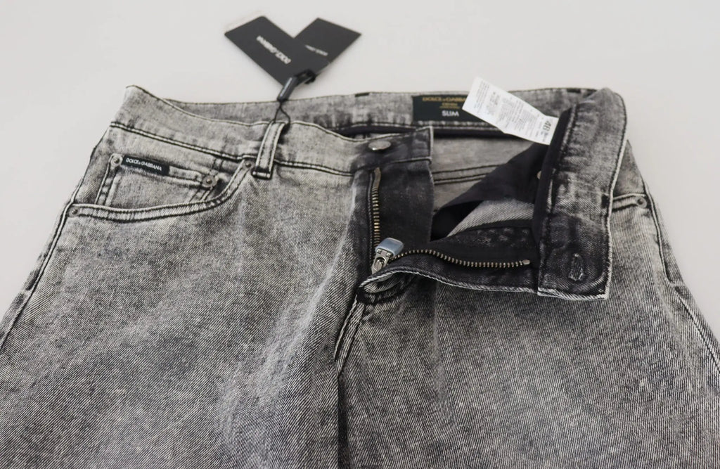 Une paire de jeans gris dolce & gabbana slim fit en denim stretch en coton avec effet délavé et coutures visibles