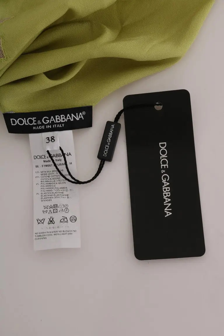 Étiquette noire dolce & gabbana avec logo blanc et taille 38 sur blouse en soie verte stretch dolce & gabbana