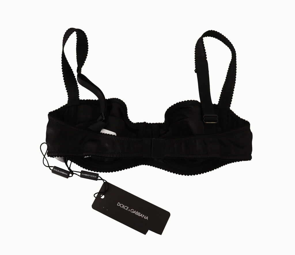 Soutien-gorge balconnet en satin noir à pois, dentelle, de la marque Dolce & Gabbana, visible en détail dans l'image.