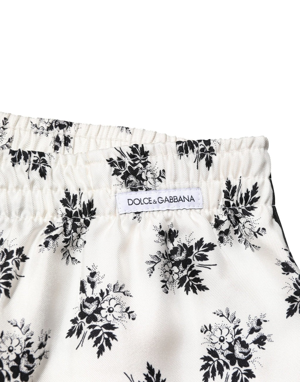 Pantalons de détente en soie blanche avec motifs floraux Dolce & Gabbana, style décontracté et élégant.