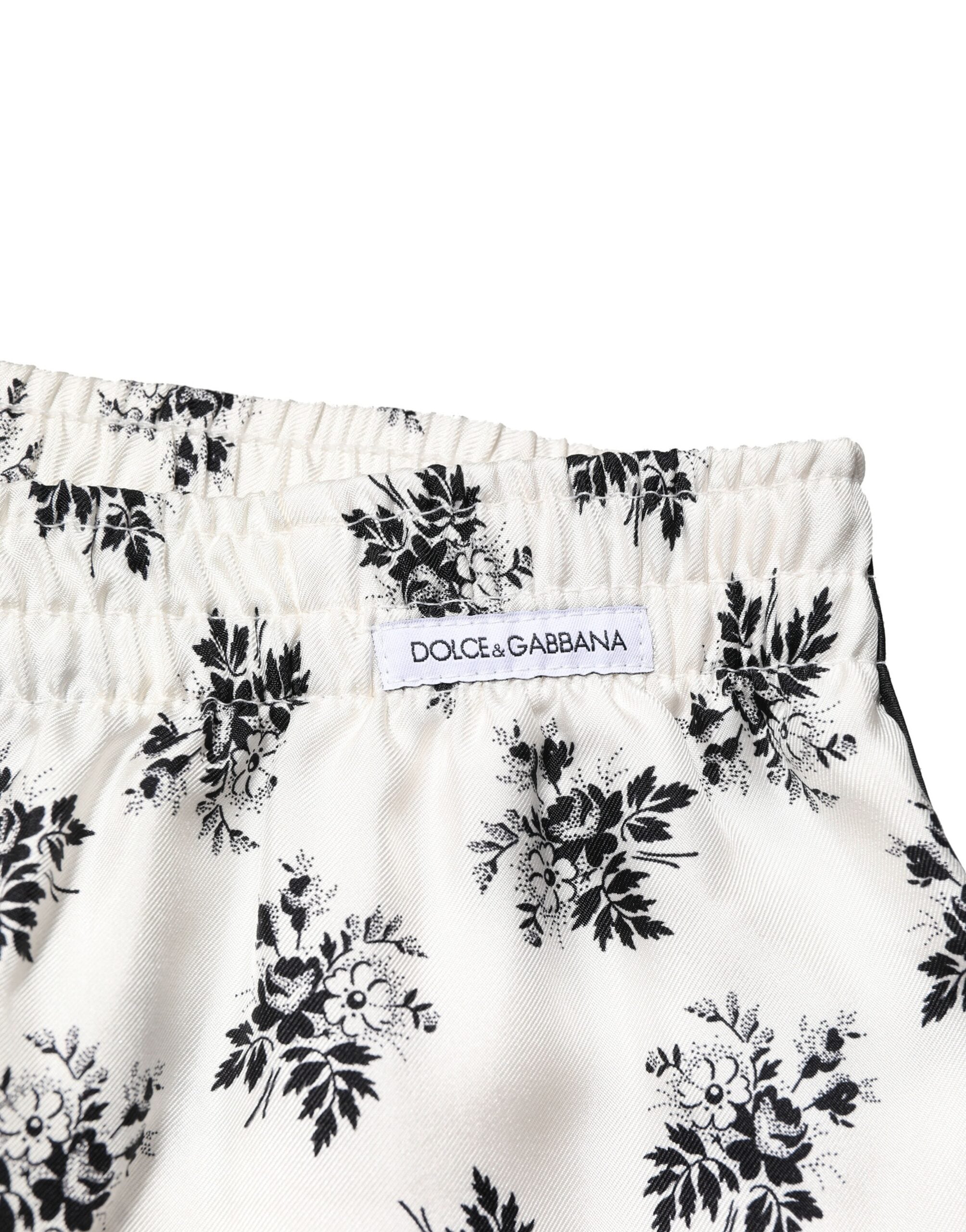Pantalons de détente en soie blanche avec motifs floraux Dolce & Gabbana, style décontracté et élégant.