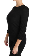 Blouse noire en dentelle florale avec fermeture éclair de la marque Dolce & Gabbana, vue de face.