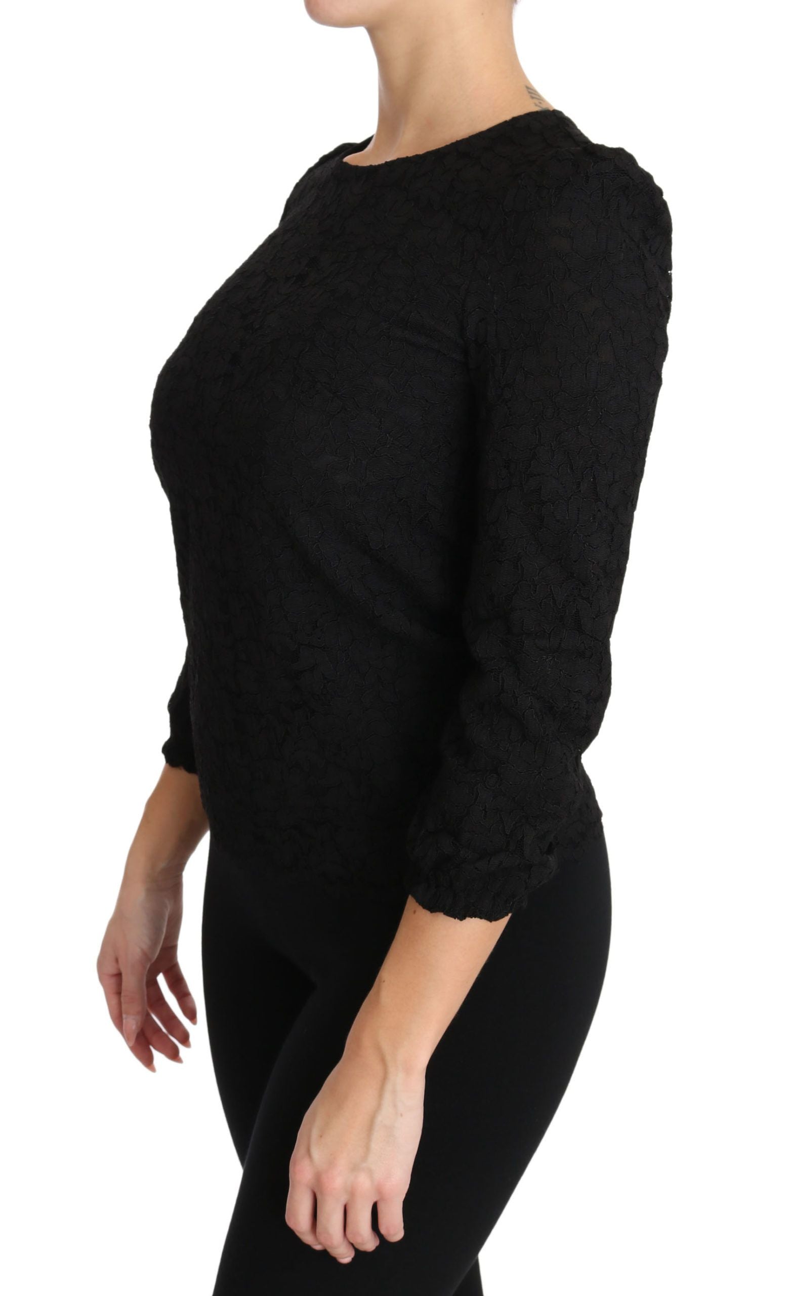 Blouse noire en dentelle florale avec fermeture éclair de la marque Dolce & Gabbana, vue de face.