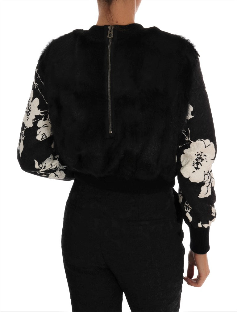 Pull Dolce & Gabbana noir en fausse fourrure et brocart floral avec fermeture éclair, détail élégant et sophistiqué.