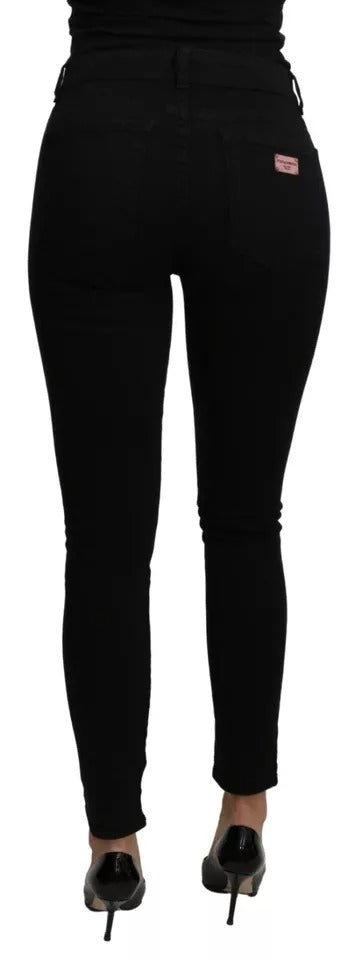 Jeans slim en coton stretch noir Dolce & Gabbana à taille moyenne, visibles sur un mannequin.