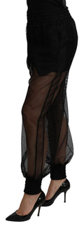 Pantalon jogger en polyester noir transparent de Dolce & Gabbana, style décontracté et élégant.