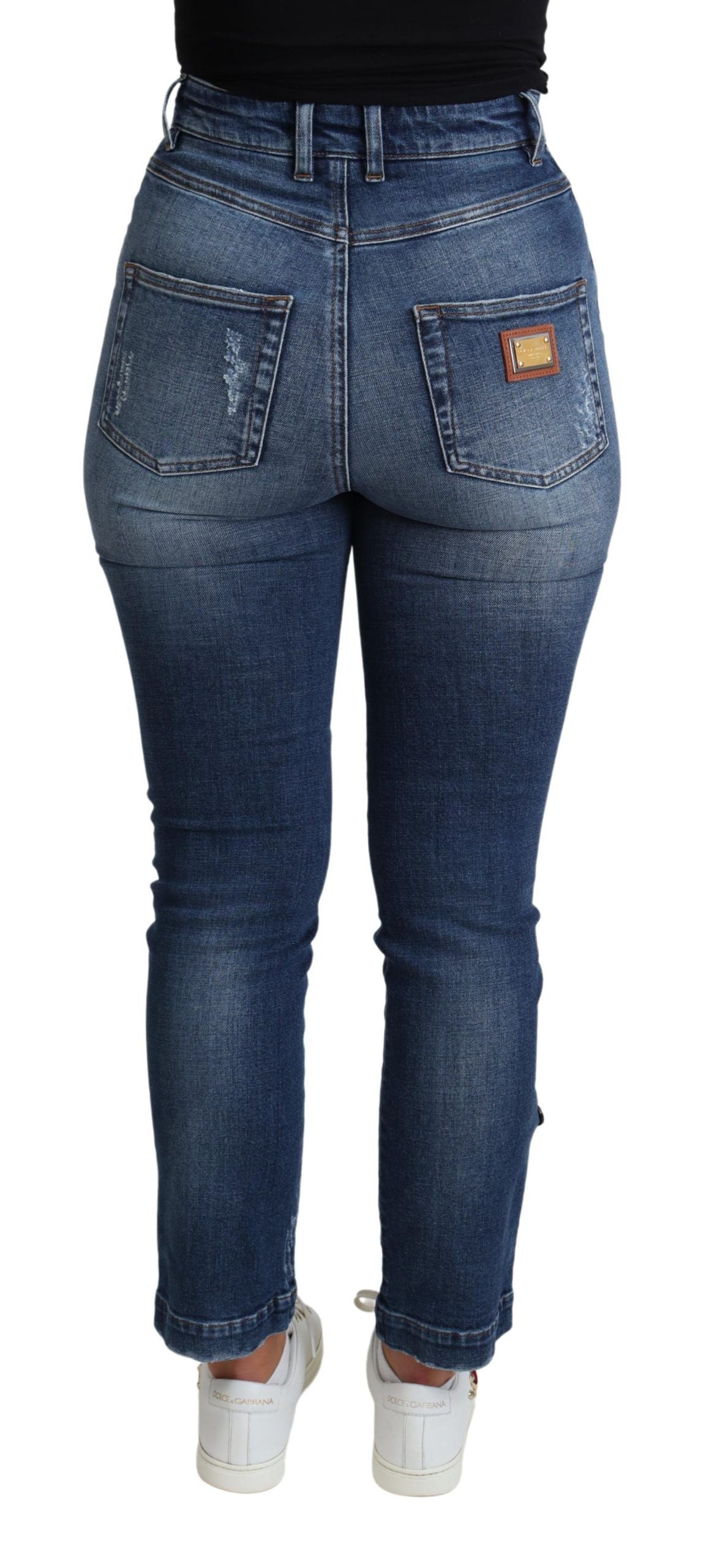 Pantalon skinny Dolce & Gabbana bleu en coton avec embellissements, style ajusté, visible en gros plan sur le jean.
