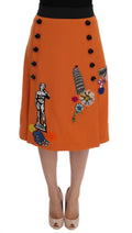 Jupe en laine orange Dolce & Gabbana avec appliqués en cristaux et sequins, élégante et ornée de détails brillants.