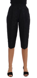 Shorts Capri en brocart noir Dolce & Gabbana avec taille haute, détail élégant et texture riche visible sur l'image.
