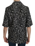 Haut en soie noir Dolce & Gabbana avec impression d'instruments de musique, style élégant et graphique.