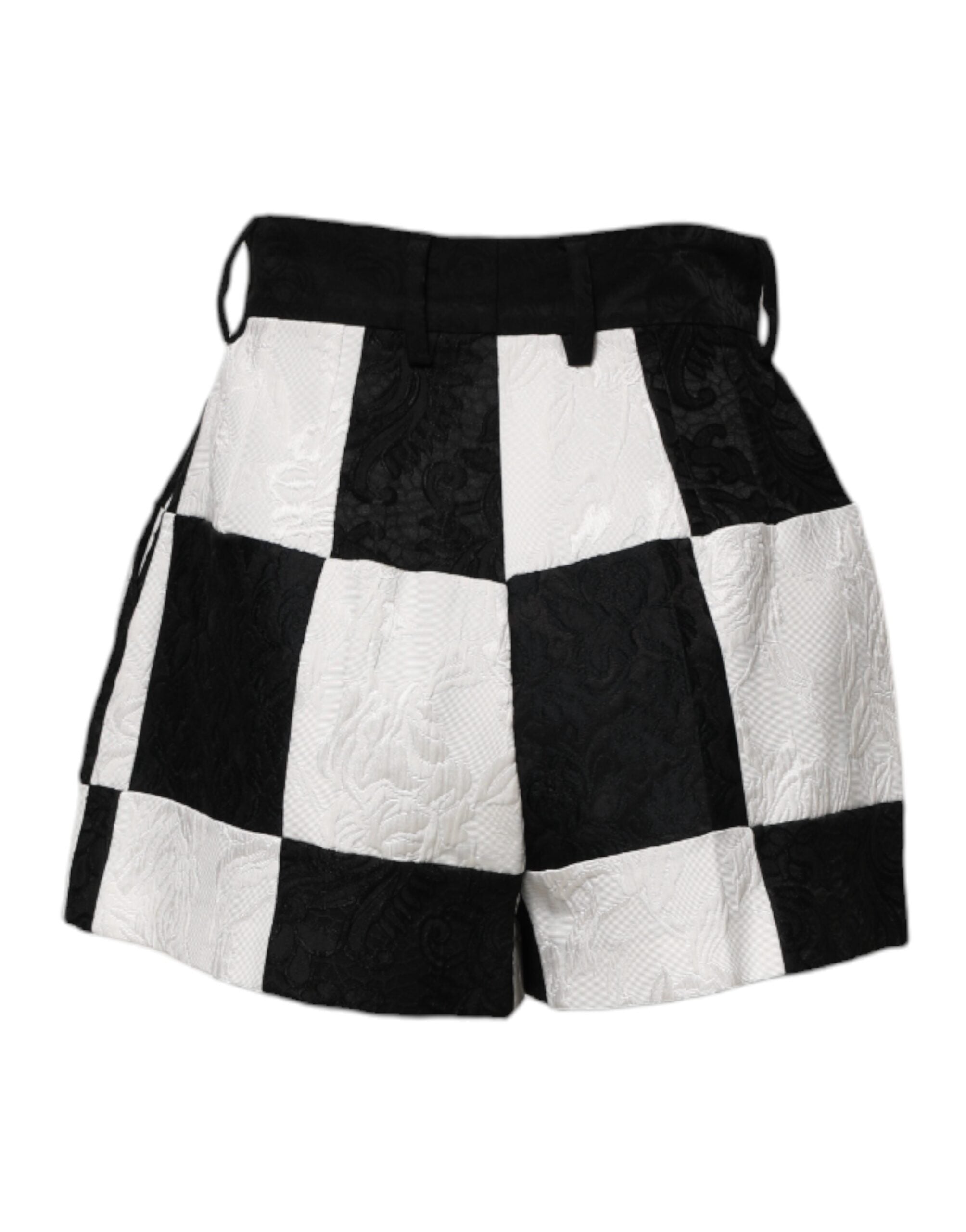 Shorts Dolce & Gabbana en brocart floral noir et blanc, style hot pants avec détails élégants et tissu luxueux.