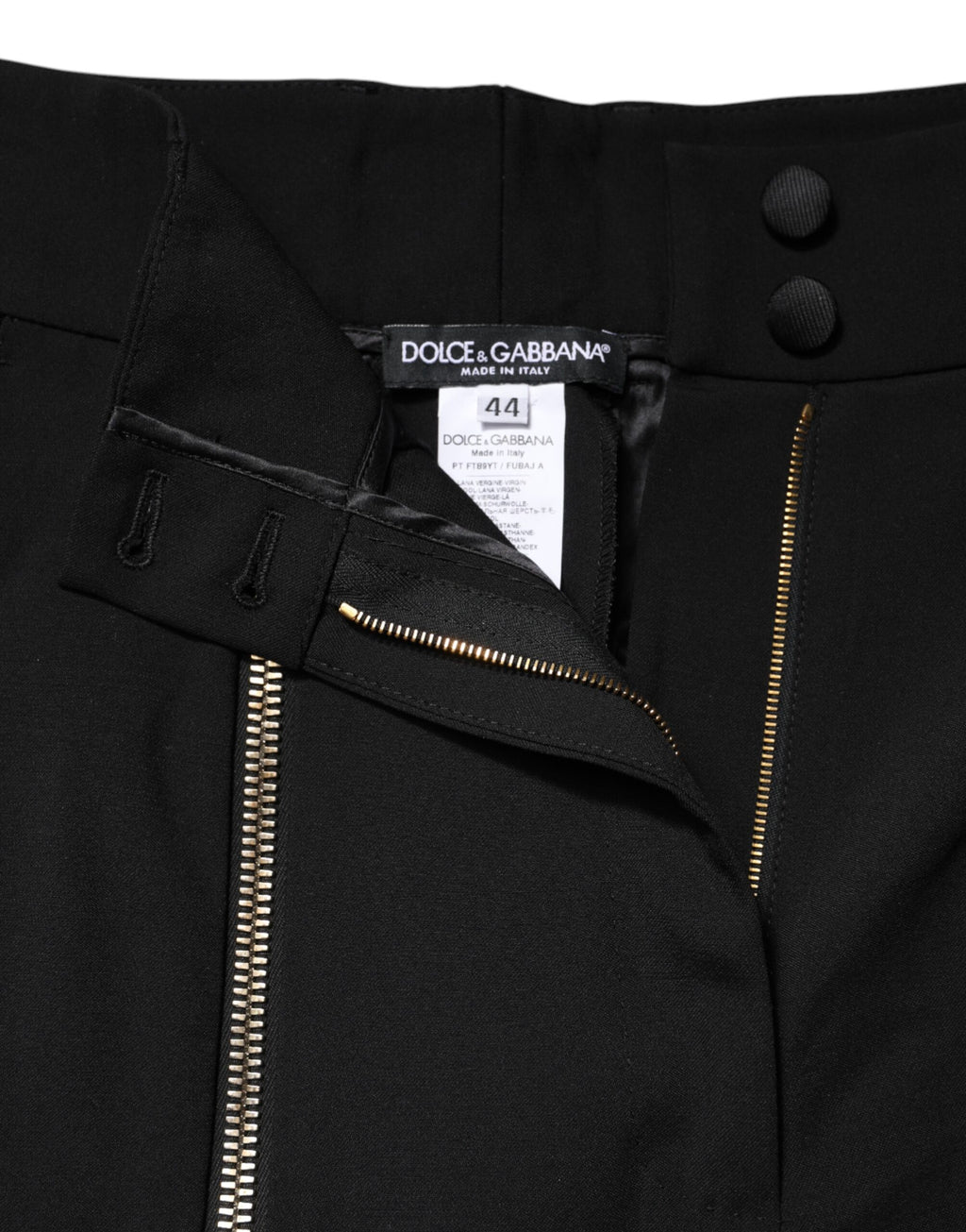 Pantalon noir en laine Dolce & Gabbana à taille haute, coupe tapered, avec fermeture éclair visible.