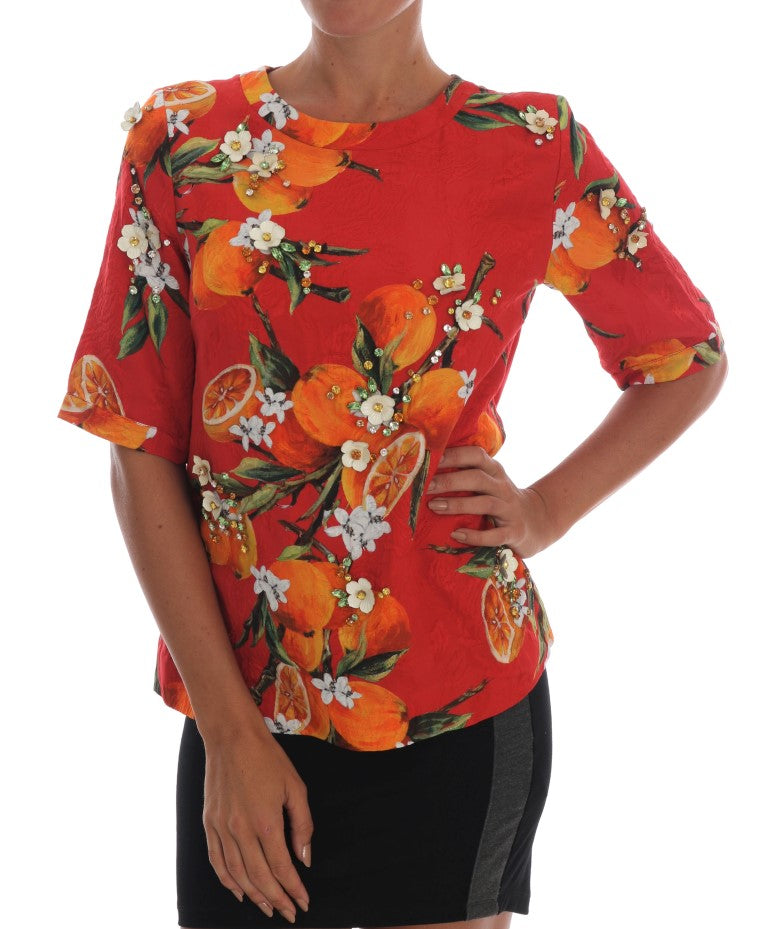 Chemisier Dolce & Gabbana à imprimé orange orné de cristaux, élégant et sophistiqué, détails visibles sur l'image.