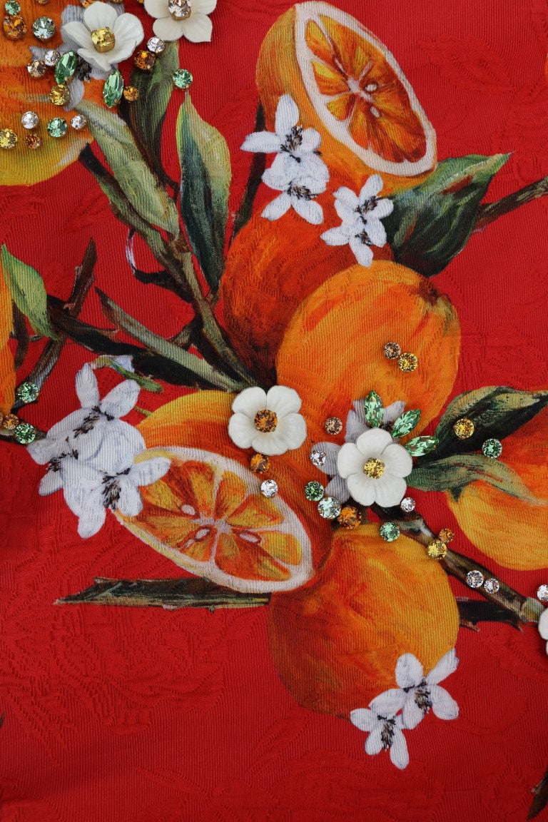 Blouse imprimé orange Dolce & Gabbana avec cristaux ornés, élégante et sophistiquée, vue en gros plan.