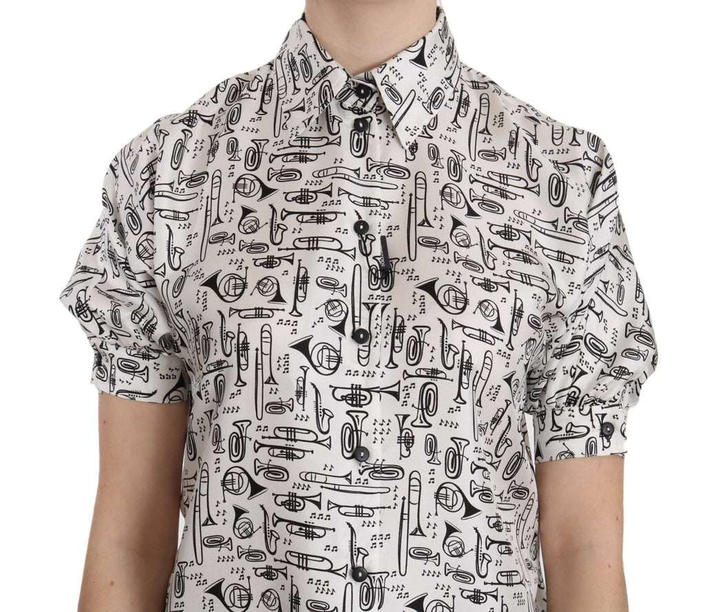 Blouse en soie à boutons Dolce & Gabbana avec imprimé trompette, style élégant et design sophistiqué visible sur l'image.