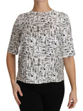 Blouse blanche Dolce & Gabbana avec imprimé d'instruments de musique, style élégant et moderne, en tissu léger.