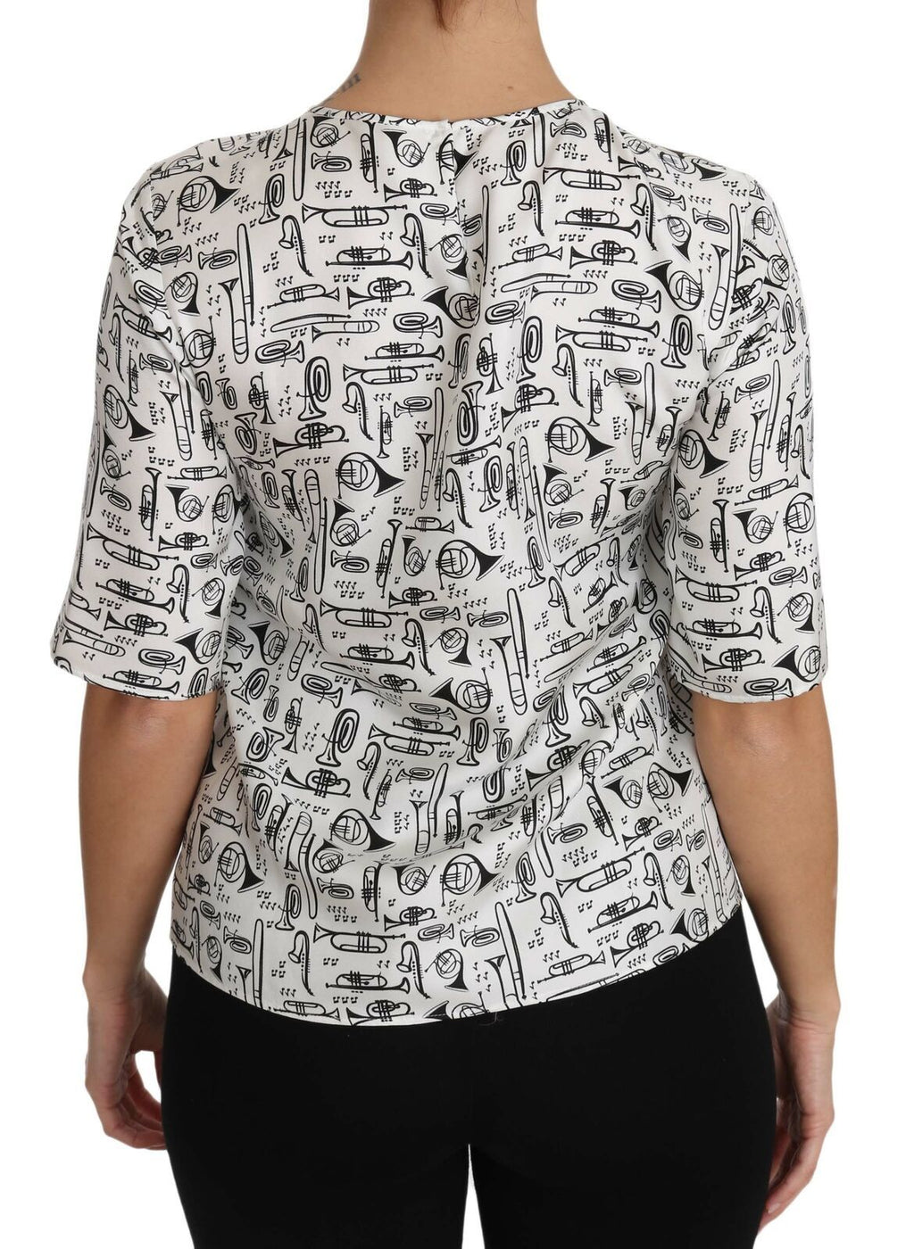 Chemisier blanc Dolce & Gabbana avec imprimé d'instruments de musique, détails élégants et tissu léger.