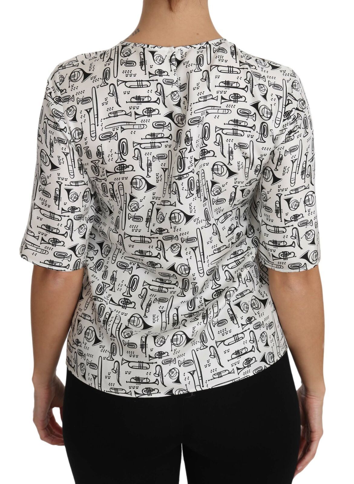 Chemisier blanc Dolce & Gabbana avec imprimé d'instruments de musique, détails élégants et tissu léger.