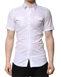 Chemise blanche en coton Dolce & Gabbana à manches courtes, style décontracté avec boutons et détails dorés visibles.