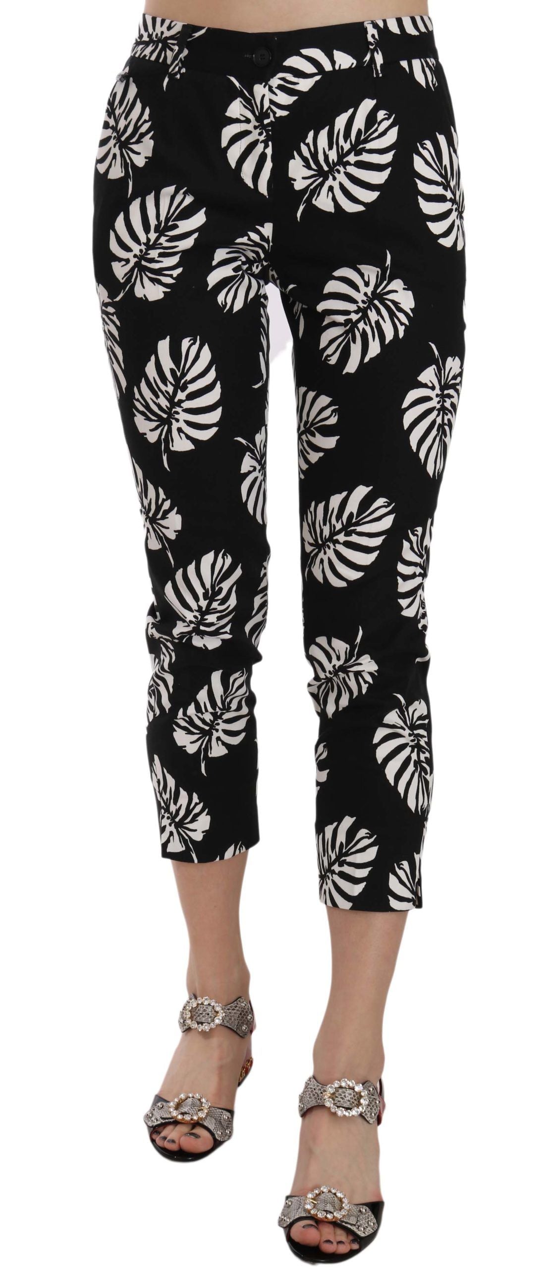 Pantalons skinny noirs Dolce & Gabbana avec imprimé palmier en vert et blanc, coupe ajustée et élégante.