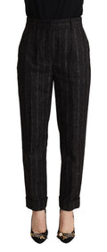 Pantalon noir à rayures, taille haute et coupe tapered, de la marque Dolce & Gabbana, visible dans l'image.
