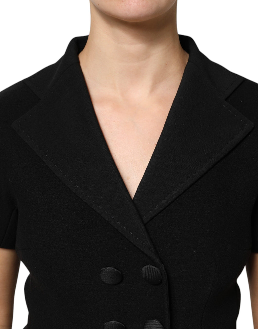 Manteau noir en laine Dolce & Gabbana à double boutonnage, veste élégante avec col classique et poches latérales.