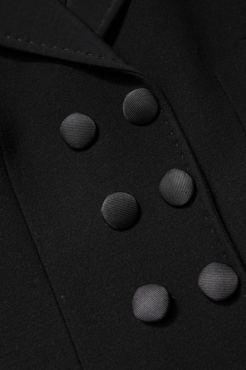 Manteau noir en laine Dolce & Gabbana, double boutonnage, veste élégante pour femme avec col classique.